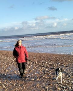 walking the dog on the beach in Deven uk